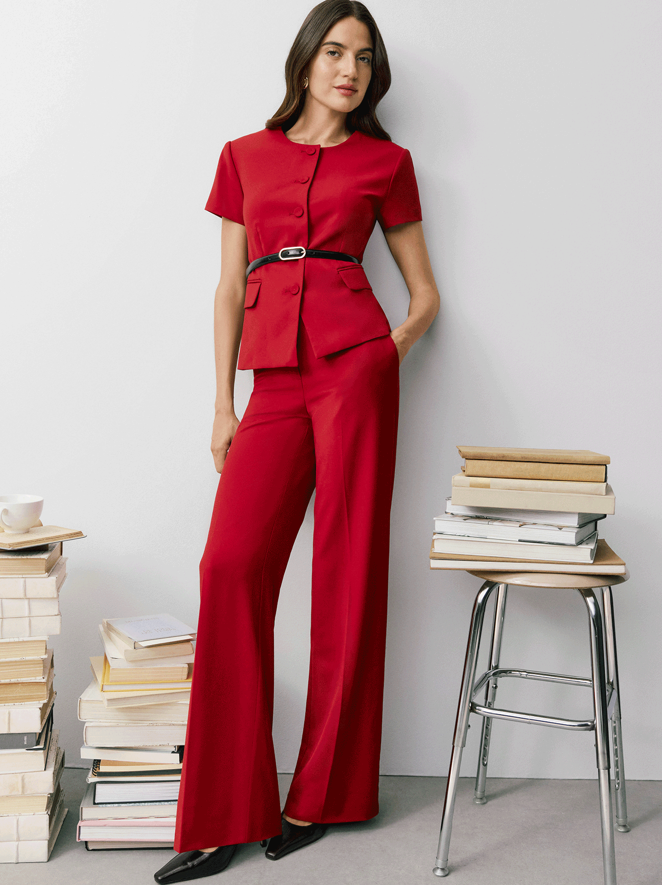 Own The Office — a model in a red belted short-sleeve jacket and wide-leg pants. Shop New Work.