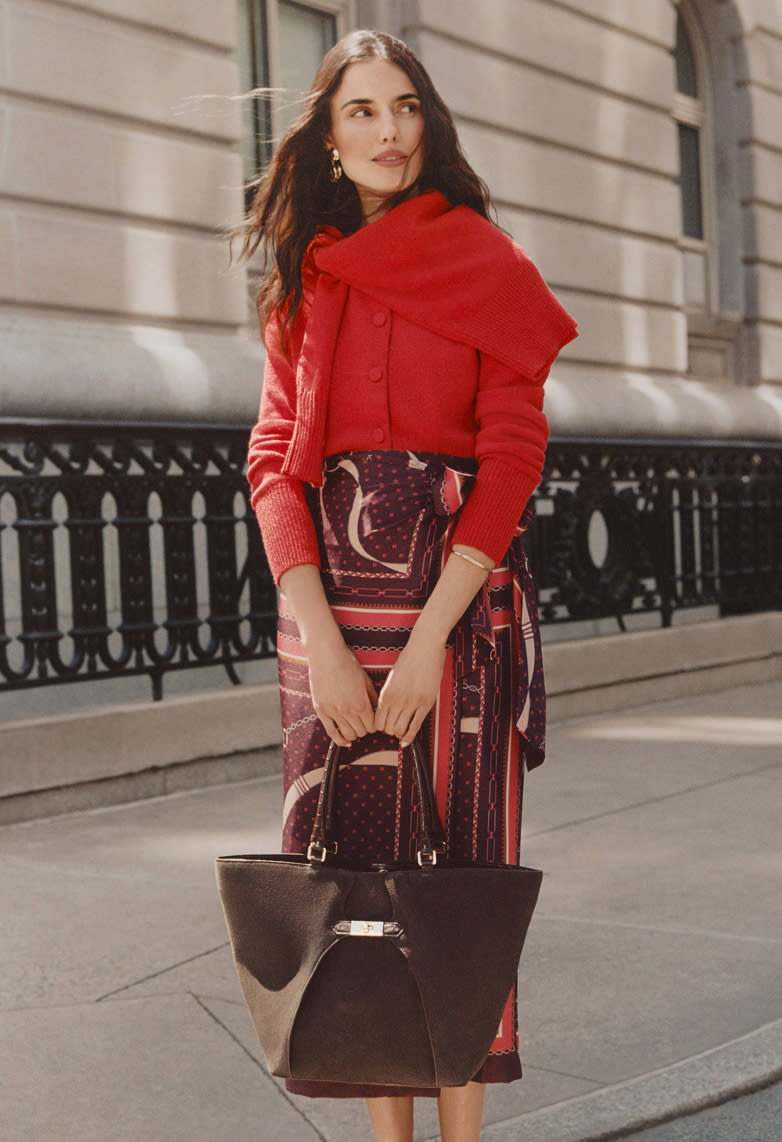 Fall trends — red shoulder-tied cardigan over a printed scarf skirt