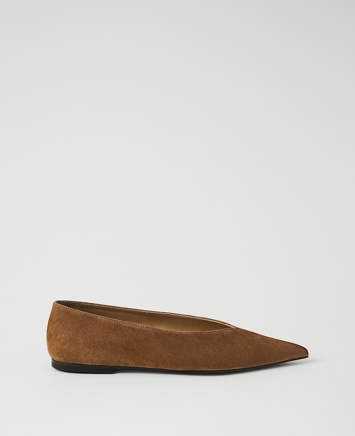 A brown suede pointed-toe flat shoe rests on a plain white background.