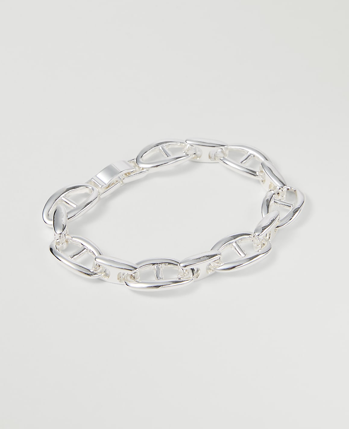 A silver anchor link bracelet rests on a plain white background.