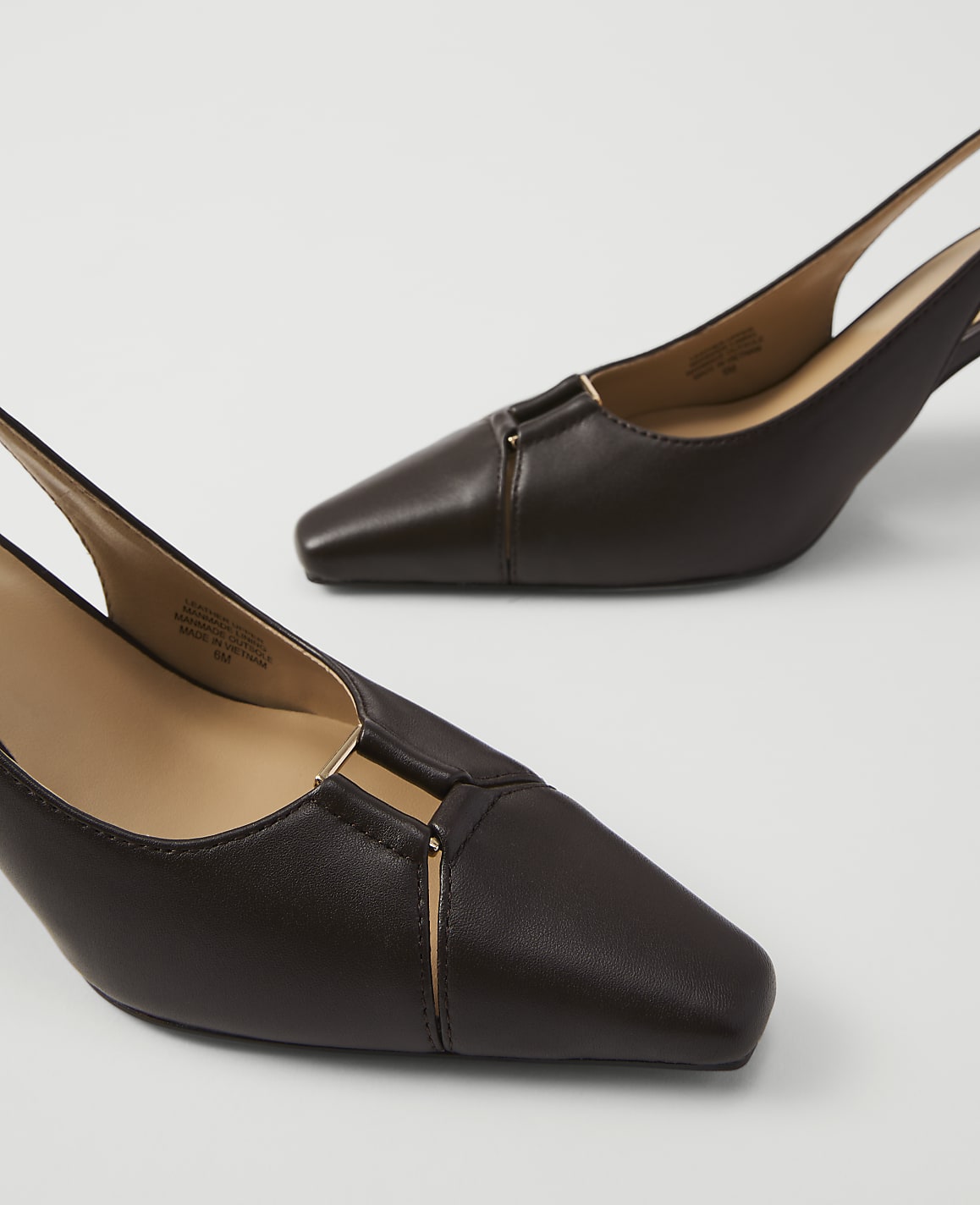 Two dark brown slingback heels with square toes and gold accents are displayed against a plain white background.