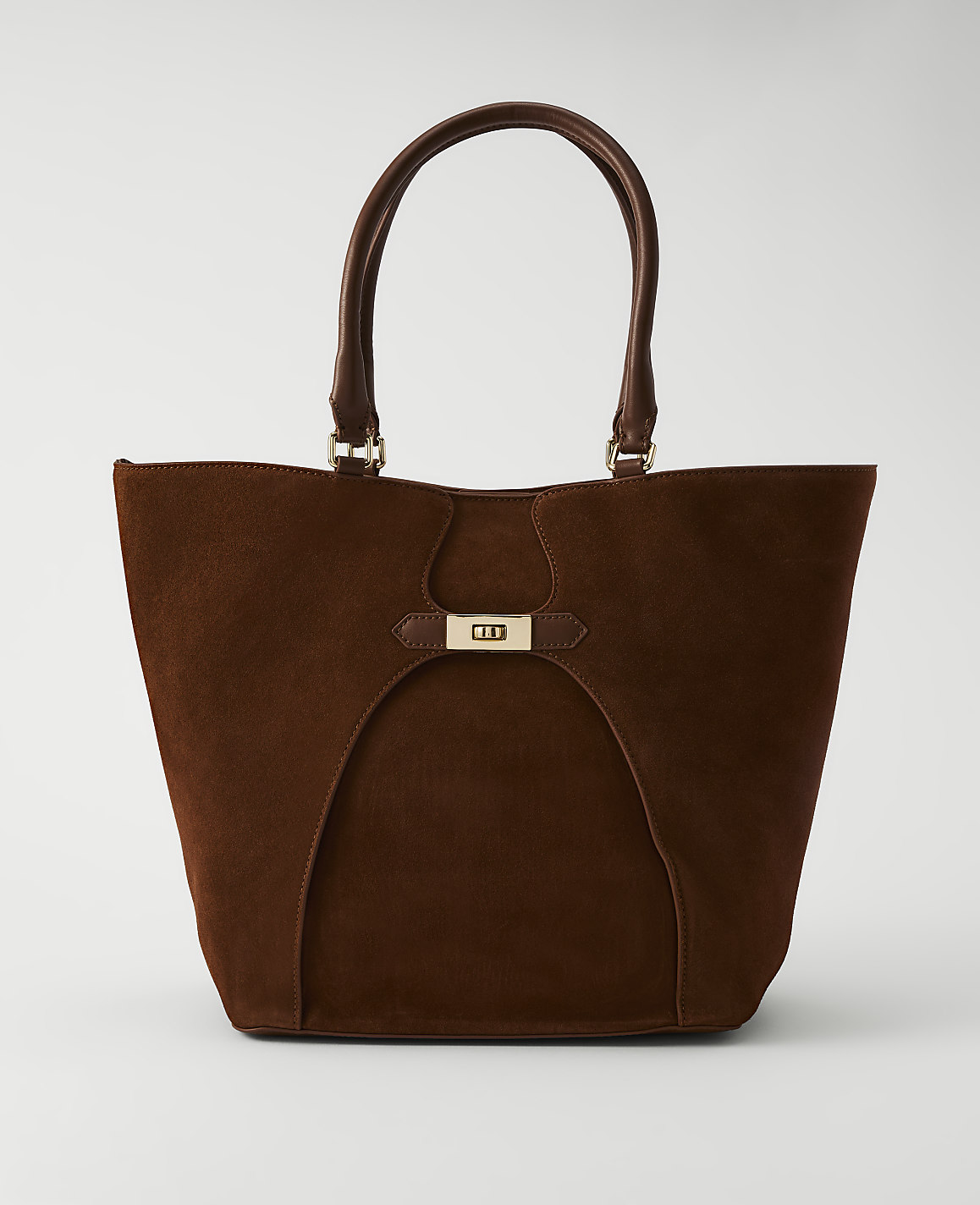 A rich brown suede tote bag with leather handles and a gold clasp sits against a plain white background.