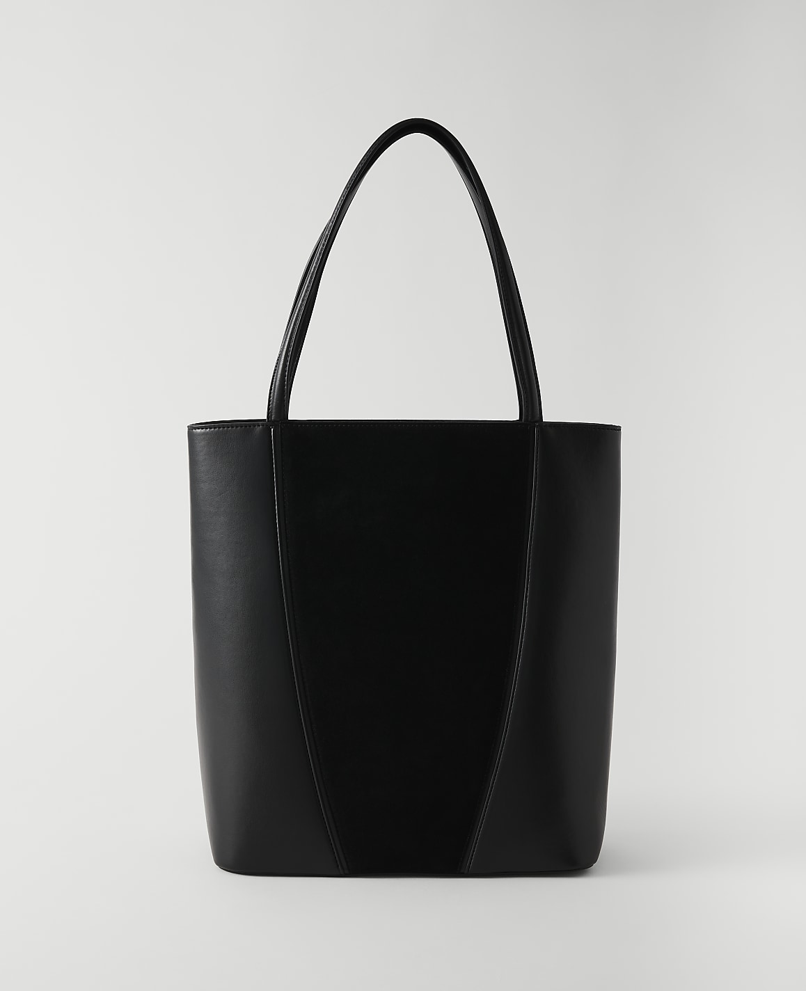 A sleek black tote bag with a V-shaped seam stands against a plain white background.