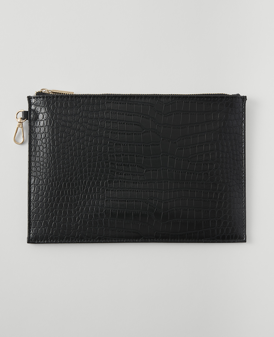 A black embossed clutch with a gold zipper and clasp rests on a plain white background.