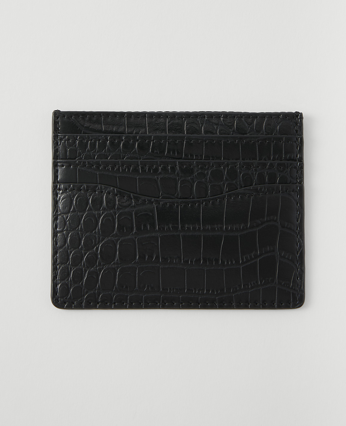 A black crocodile-embossed cardholder with multiple slots rests on a plain white background.