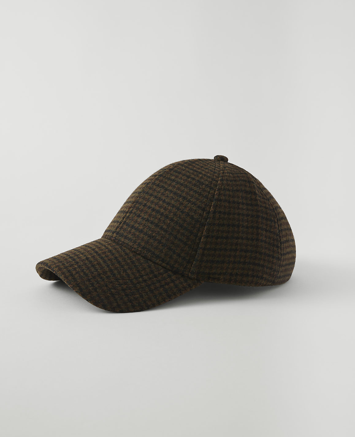A brown and black checkered baseball cap rests on a plain white background.
