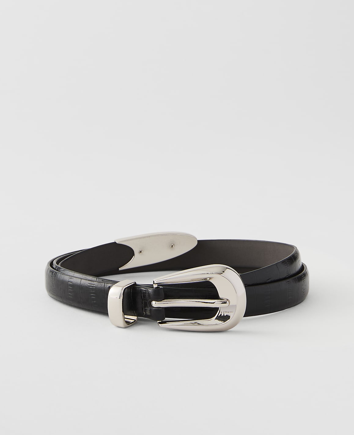 A black textured leather belt with a silver buckle rests on a plain white background.