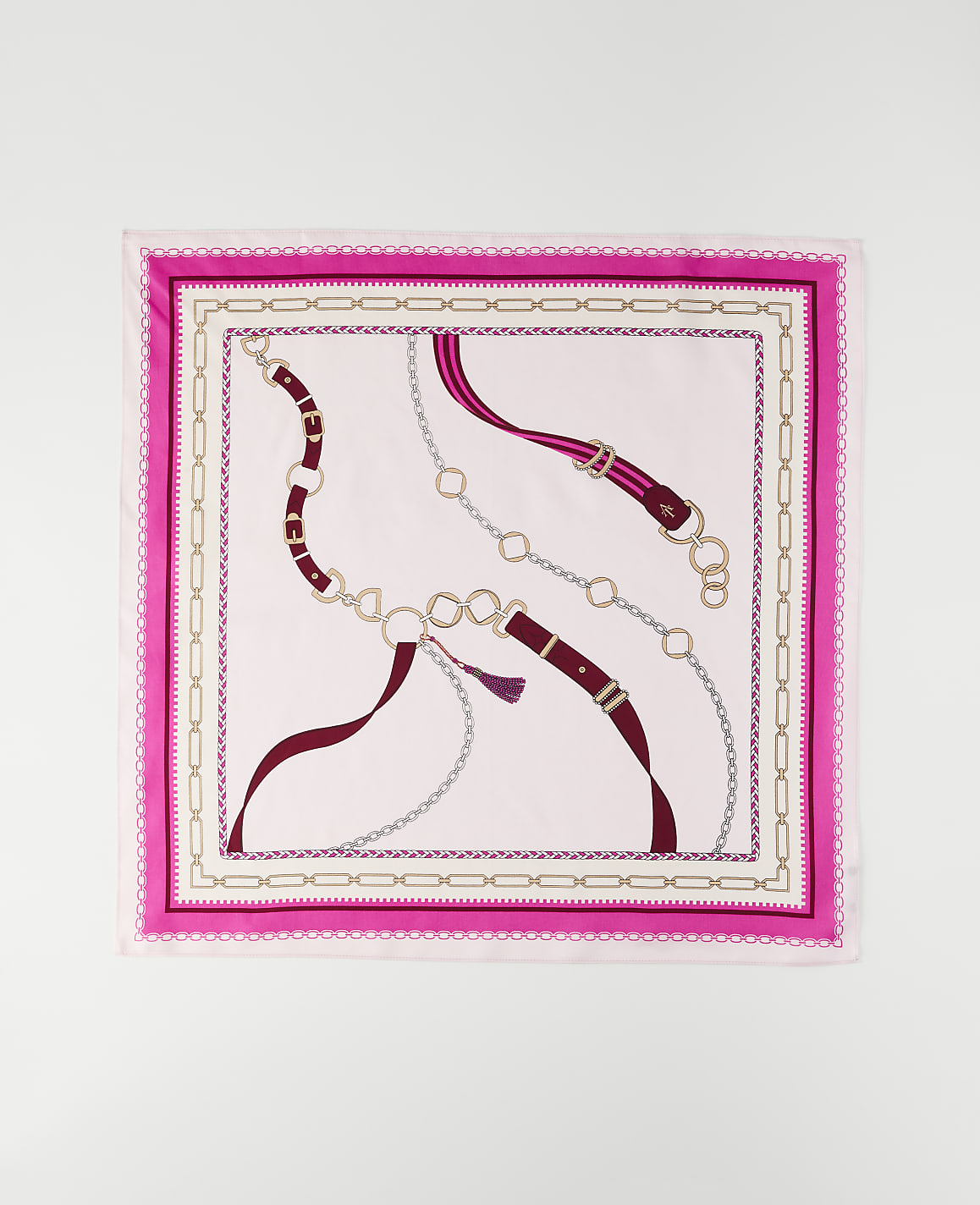 A pink and white patterned scarf with chain and belt motifs is laid flat against a white background.
