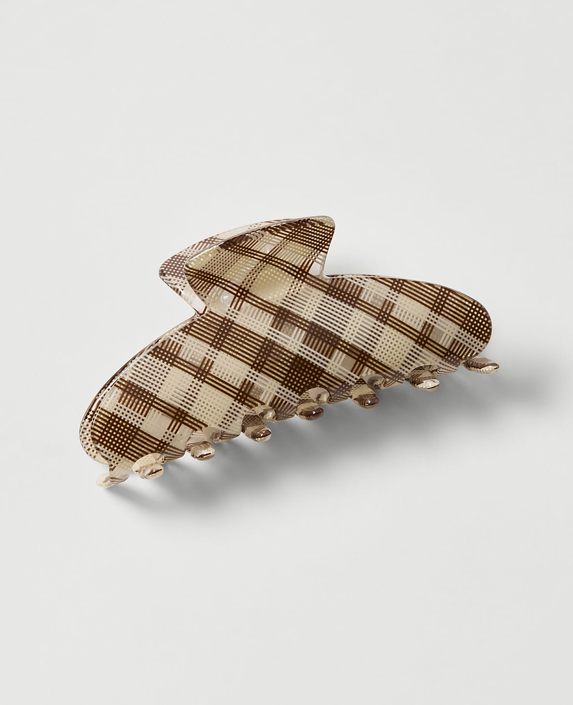 A brown and cream checkered hair claw sits on a plain white background.