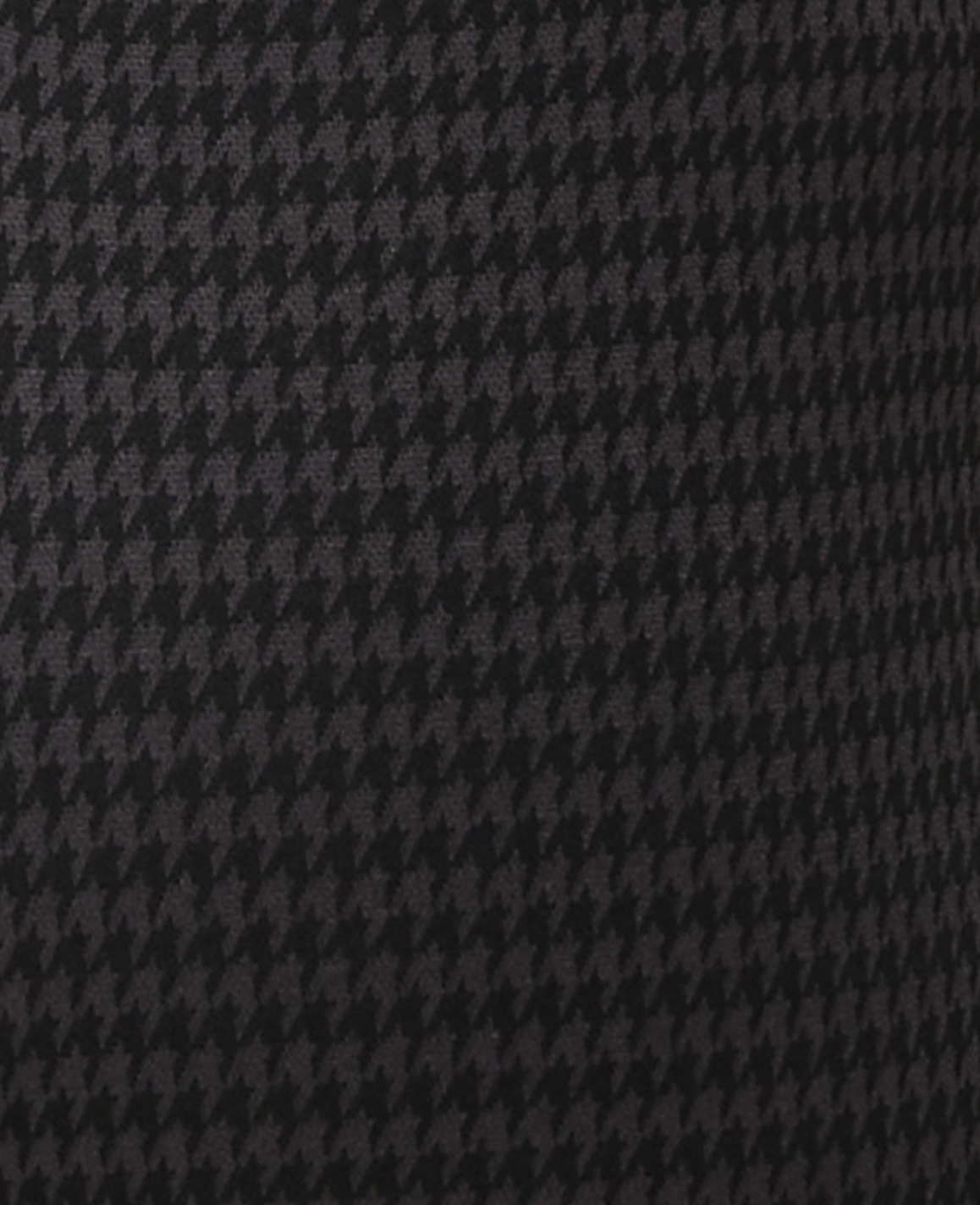 A close-up view of a dark gray and black houndstooth pattern fills the frame, with no discernible background.
