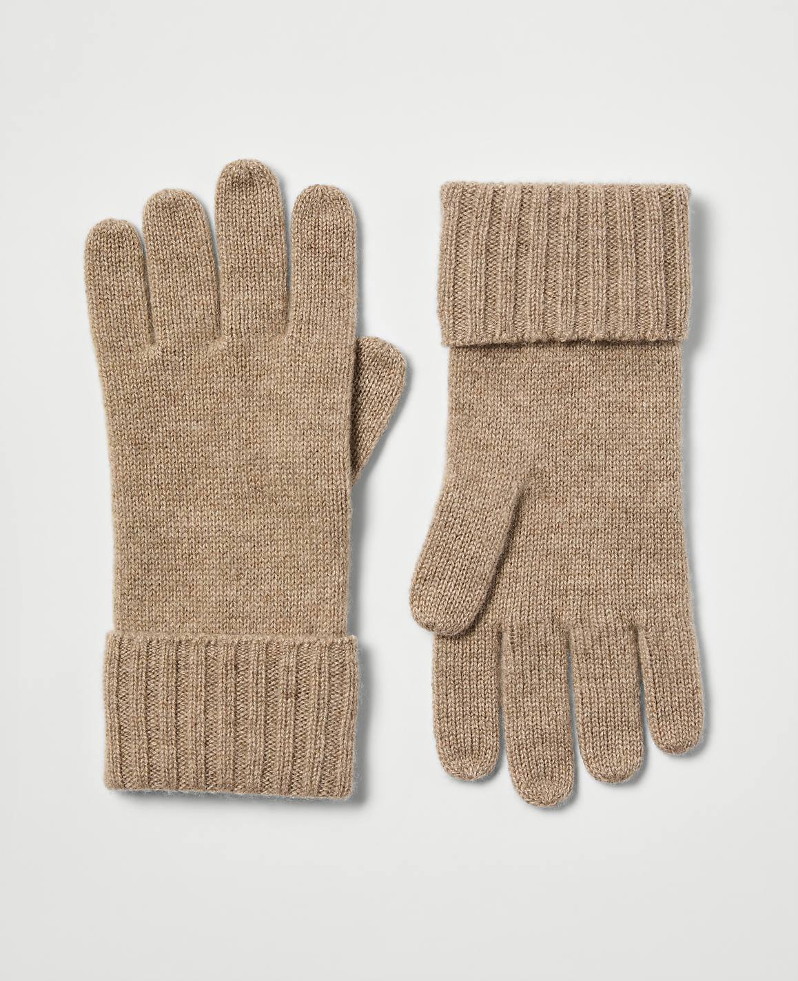 A pair of tan knit gloves with cuffed wrists rests on a plain white background.