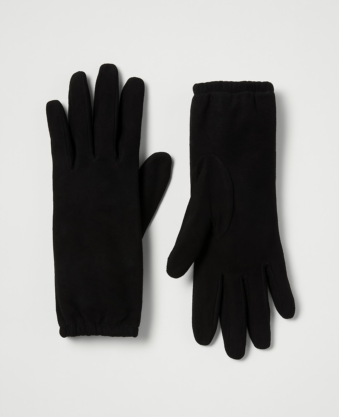 A pair of black fleece gloves lies flat on a plain white background.