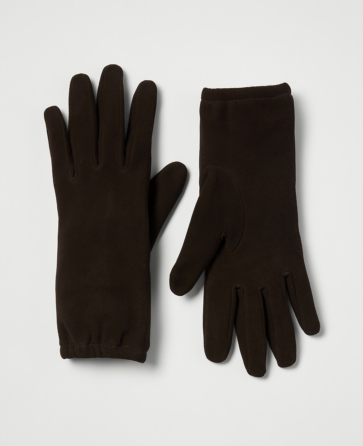 A pair of dark brown fleece gloves are laid out on a plain white background.