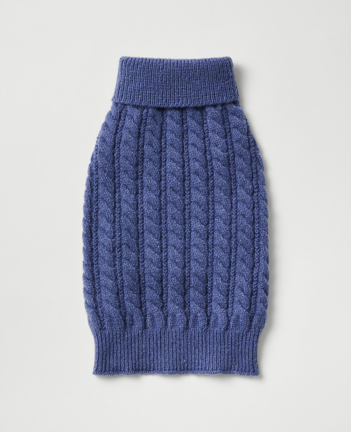 A blue cable-knit sweater for a pet is centered against a plain, light gray background.