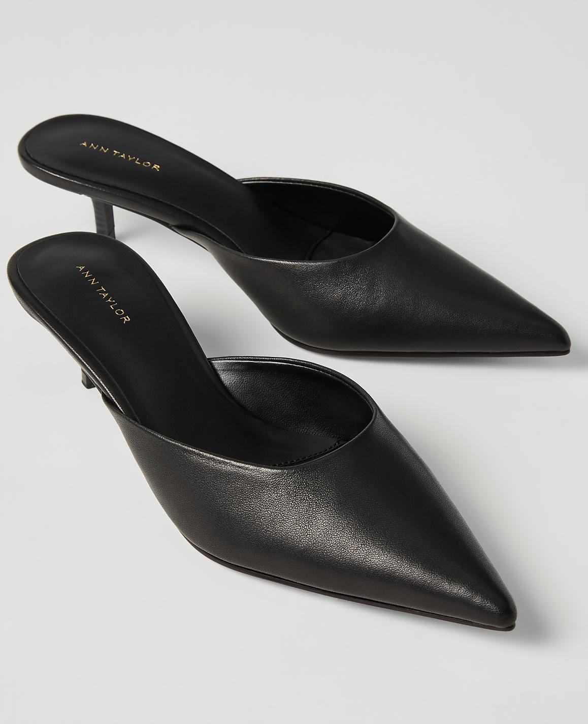 A pair of black pointed-toe Ann Taylor mule heels rests on a plain white background.