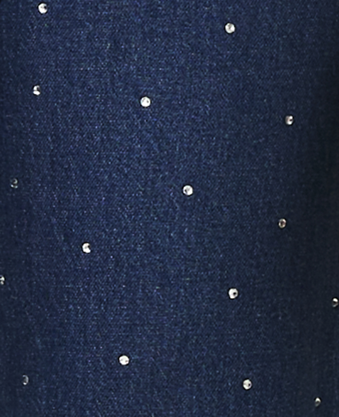 Small, sparkling rhinestones are scattered across a dark blue textured fabric background.