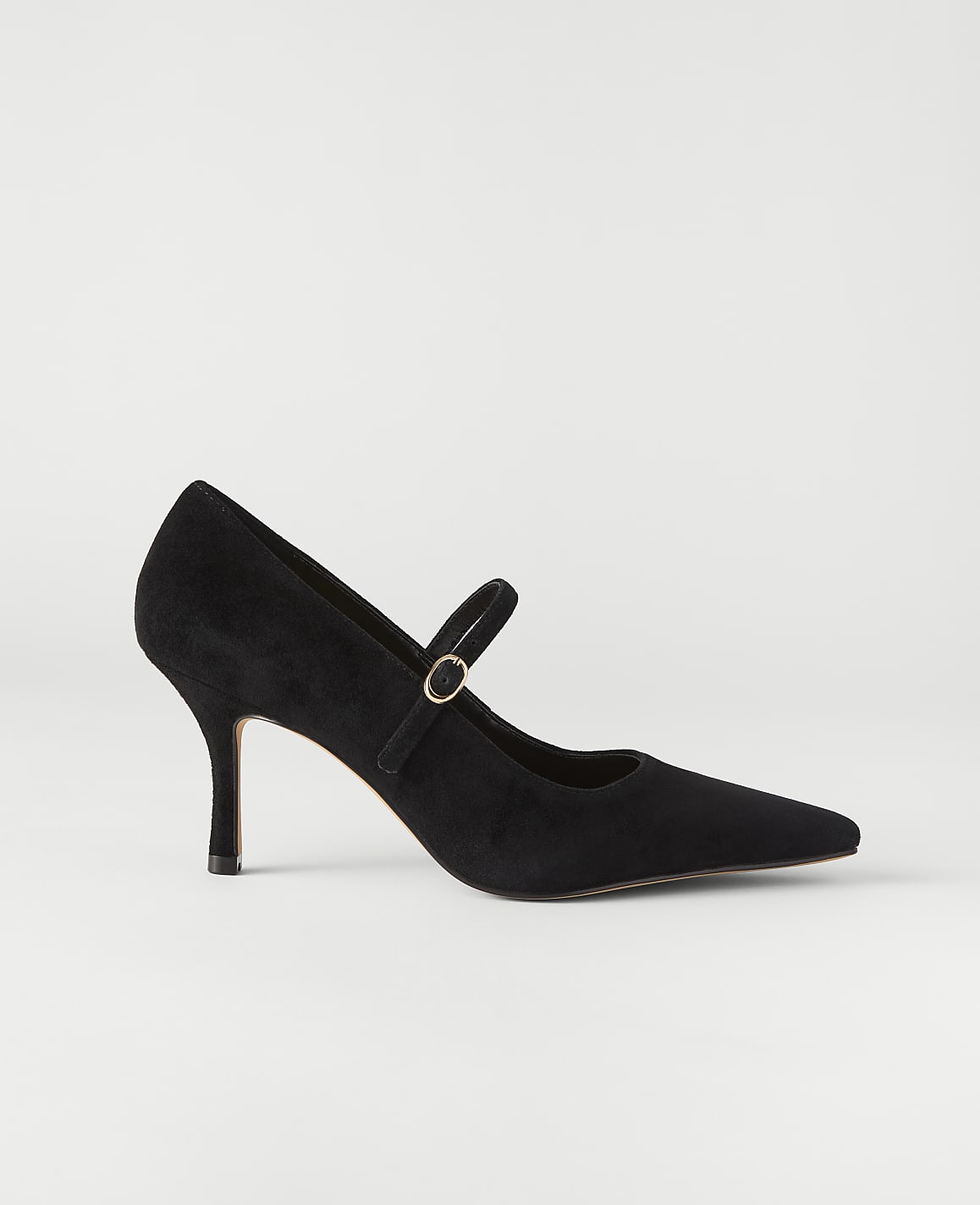 A black suede pointed-toe pump with a gold buckle strap sits against a plain, light grey background.
