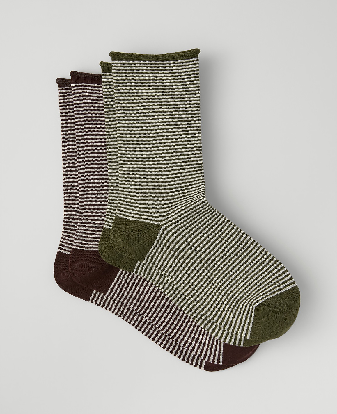 Three pairs of striped socks in olive, burgundy, and dark brown are layered against a plain light gray background.