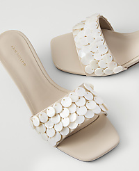 A pair of cream-colored slide sandals with sequined straps are displayed against a plain white background. carousel Product Image 2