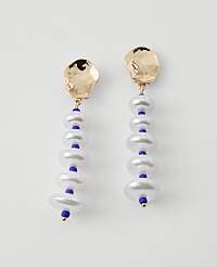 A pair of gold-topped earrings with stacked white pearls and blue beads hang against a plain white background. carousel Product Image 1