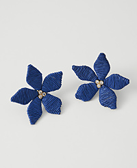 Two blue floral earrings with jeweled centers rest on a plain white background. carousel Product Image 1