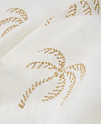 A close-up of a white fabric with embroidered golden palm trees in the foreground and background. carousel Product Image 2