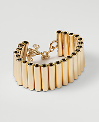 A gold cuff bracelet with a series of vertical tubes is displayed against a plain white background. carousel Product Image 1