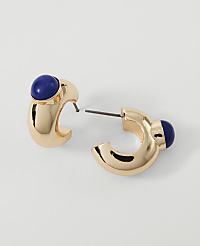 Gold hoop earrings with blue stone accents rest on a plain white background. carousel Product Image 1