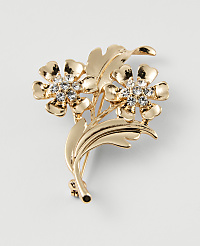 A gold floral brooch with clear rhinestones in the center of the flowers rests against a plain white background. carousel Product Image 1