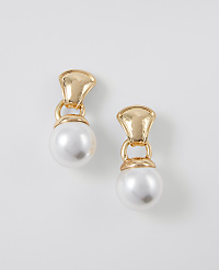 A pair of gold and pearl drop earrings hang against a plain white background. carousel Product Image 1