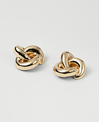 Two gold knot-shaped earrings rest on a plain white background. carousel Product Image 1