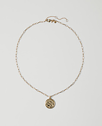 A delicate gold chain necklace with a circular pendant rests on a plain white background. carousel Product Image 1