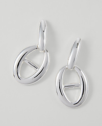 A pair of silver oval link earrings hang against a plain white background. carousel Product Image 1