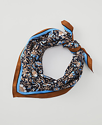 A dark blue floral patterned silk scarf with brown and light blue trim is tied in a knot against a plain white background. carousel Product Image 1