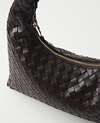 A dark brown woven leather handbag with a gold zipper is presented against a plain white background. carousel Product Image 2