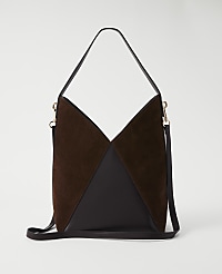 A brown suede and leather hobo bag with a single strap and a detachable crossbody strap rests against a plain white background. carousel Product Image 1
