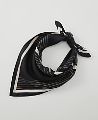 A black silk scarf with white geometric lines is tied in a knot against a plain white background. carousel Product Image 1