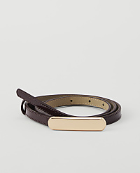 A thin, dark red patent leather belt with a gold buckle is coiled on a plain white background. carousel Product Image 1