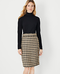 A woman in a black turtleneck and a houndstooth skirt stands against a plain white background. carousel Product Image 1
