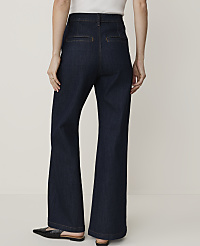 A person wearing dark wash wide-leg jeans and black flats stands against a plain white background. carousel Product Image 3