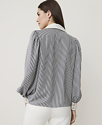 A woman in a striped blouse and white pants stands against a plain, light background. carousel Product Image 2