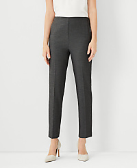 A person stands in the foreground wearing dark gray pants and light-colored heels against a plain white background. carousel Product Image 1
