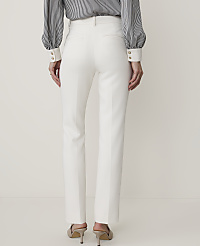 A person wearing white trousers and a striped blouse stands against a plain white background. carousel Product Image 3
