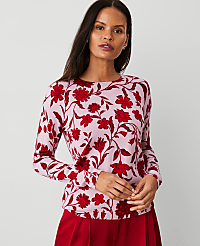 A woman in a pink floral sweater and red satin pants stands against a plain background. carousel Product Image 1