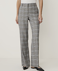 A person stands in the foreground wearing plaid trousers and black flats against a plain, light-colored background. carousel Product Image 1