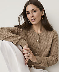 A woman in a tan cardigan and white pants poses against a plain, light background. carousel Product Image 3