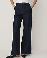 Dark wash flared jeans with a white top and black pointed-toe flats are displayed against a plain white background. carousel Product Image 2