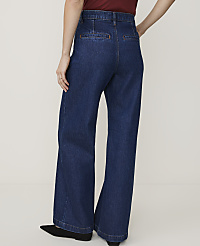 A person wearing dark wash wide-leg jeans stands against a plain white background. carousel Product Image 3
