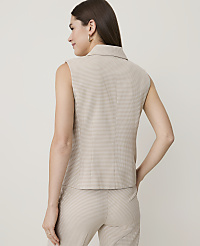 A woman in a patterned sleeveless top and pants stands against a plain, light-colored background. carousel Product Image 2