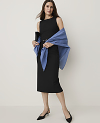 A woman in a black dress and blue shawl stands against a plain white background. carousel Product Image 1